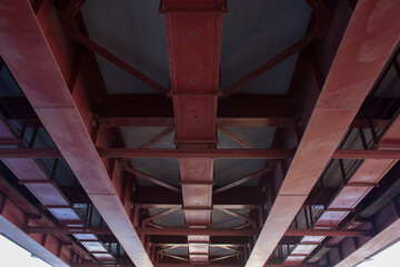 Bottom view of a fragment of an automobile bridge. Concrete and metal.