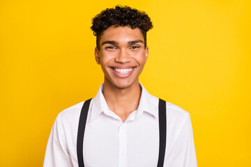 Photo portrait of african american guy smiling isolated on vivid yellow colored background