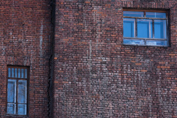 an interesting fragment of an old red brick wall, non-standard windows