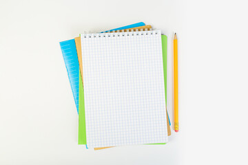top view of an open notebook with a pencil on a gray background, school notebooks with a spiral spring, office notepad. desktop concept, learning