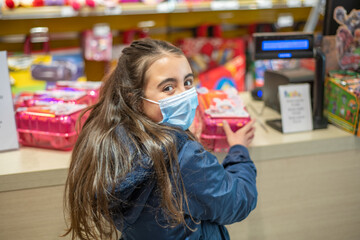 Happy young girl buying new gift at the toy shop