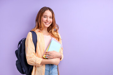 Diligent Shy Caucasian Student Girl Carrying School Bag And Books Posing At Camera