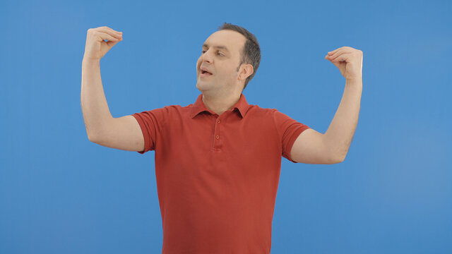 Male mocks the interlocutor showing a hand blah blah blah gesture.Movements and body language concept.Indoor studio shot isolated on blue background