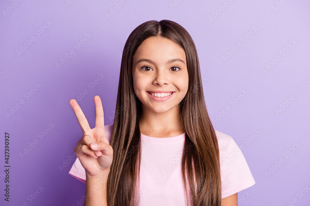 Sticker Photo of optimistic nice brunette girl show v-sign wear t-shirt isolated on pastel purple color background