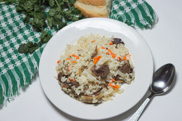 Pilaf on a light background. A plate of pilaf with meat. home cooking