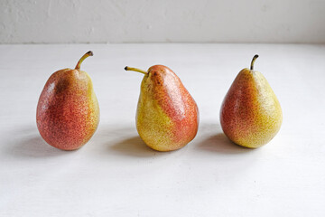 Trendy ugly organic fruits -three yellow pears on the table.  Buying imperfect products is a way to deal with food waste. Horizontal.
