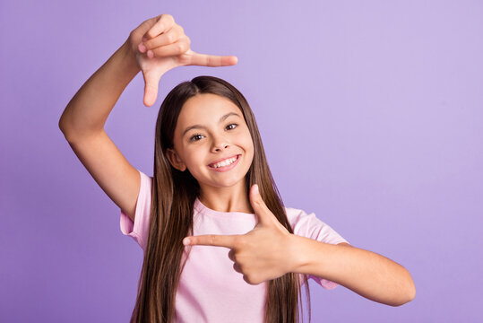 Photo of young cheerful girl happy positive smile make fingers border frame photographer cadre isolated over purple color background