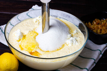 The process of making pancake dough. The blender beats the batter. Granulated sugar and eggs in batter.