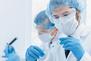 close up. group of scientists in protective clothing working in the laboratory.