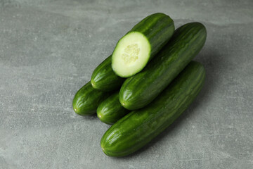 Ripe cucumbers on gray background, close up