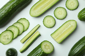 Flat lay with ripe cucumbers on white background
