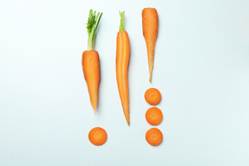 Flat lay with carrot slices on white background