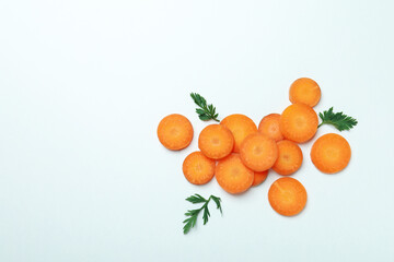 Carrot slices and leaves on white background