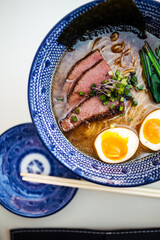 Closeup on japanese ramen soup with beef pastrami and eggs