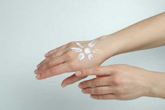 Female Hands With Sunscreen On White Background