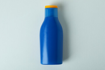 Blank blue bottle of sunscreen on white background