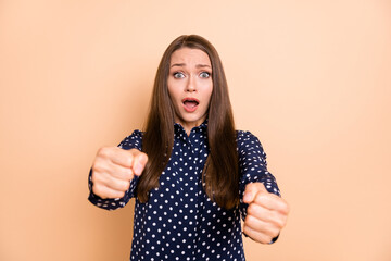Photo of shocked shiny young girl dressed dotted blouse driving car open mouth isolated beige color...