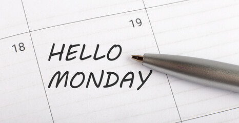 Text HELLO MONDAY written on a calendar planner to remind you an important appointment with a pen on isolated white background.