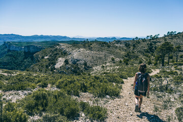 Fototapeta premium woman hiking on a mountain path in catalonia