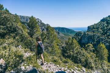 Fototapeta na wymiar woman hiking on a mountain path in catalonia