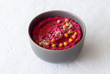 Beet hummus in a gray bowl. Healthy eating. Vegetarian food.