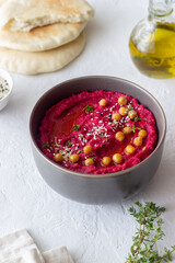 Beet hummus in a gray bowl. Healthy eating. Vegetarian food.