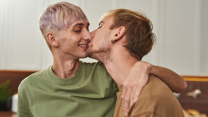 Portrait of happy young same sex male couple kissing