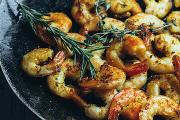 Fried shrimps with rosemary close-up