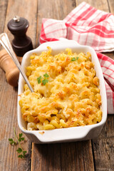 pasta and cheese gratin on wood background