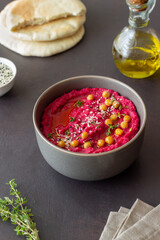 Beet hummus in a gray bowl. Healthy eating. Vegetarian food.