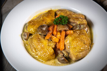 Recipe for chicken fricassee in white wine, with a carrot and mushroom planter, High quality photo