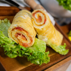 Tomato-rolled egg omelette recipe on a bed of salad, High quality photo - obrazy, fototapety, plakaty