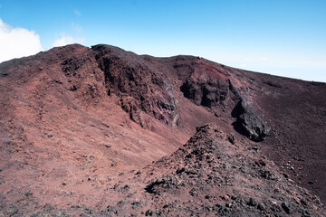 Mount Etna in Sicily near Catania, Tallest active Europe volcano in Italy. Red and purple lava fields around one of the craters.