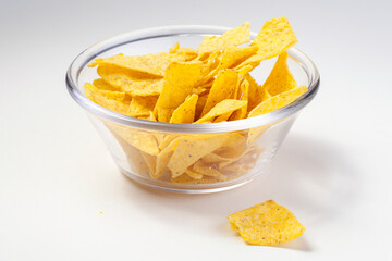 Nachos chips in glass bowl on isolated background
