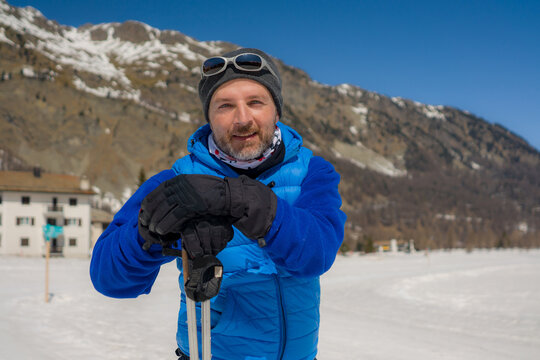 Lifestyle Portrait Of Young Happy And Attractive Man Doing Cross Country Ski Enjoying Winter Holidays On Swiss Alps Having Fun On Snow At Beautiful Alpine Landscape