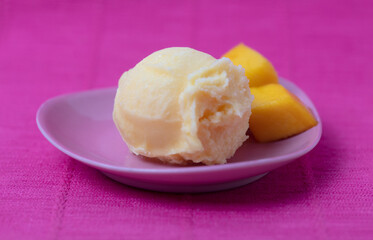 Mango ice cream scoop or mango sorbet with mango pieces