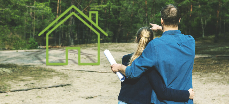 young couple looking for plot of land and dreaming about small forest lodge