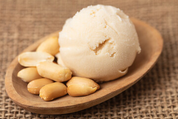 Fototapeta na wymiar Scoop of peanut ice cream or peanut butter ice cream with peanuts