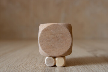Wooden dice on wooden table