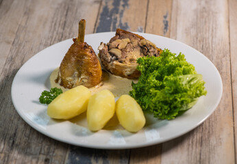 Chicken gigolette recipe with mushrooms accompanied by turned potatoes and salad, creamy sauce, High quality photo