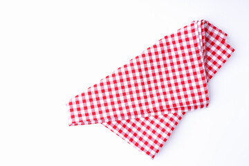 The napkin checkered red and white folded places on a white background with copy space, top view, flat lay.