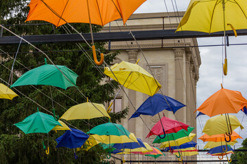 Umbrellas on a city street after a strong wind. A stormy wind swept through the city. Colored...