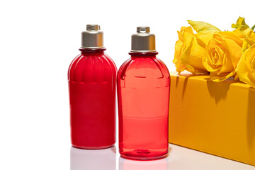 Red bottles for shower gel and cream on a white background. Lightweight plastic jars. On white background. Hard shadows. Isolates.