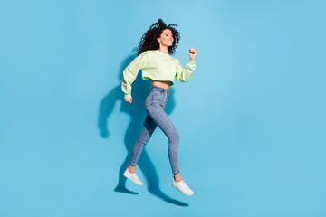 Full length profile portrait of carefree pretty person look empty space running isolated on blue color background