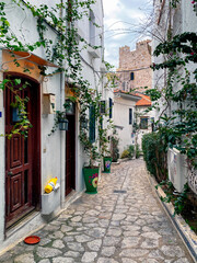 Fototapeta na wymiar Beautiful Streets of old Marmaris. Narrow streets with stairs among the houses with white brick, green plants and flowers in the old town of resort of in Turkey