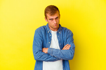 Young caucasian man isolated on yellow background