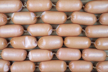 Sausages in natural shell against background from natural wood. meat products