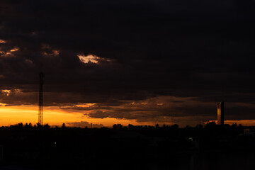 Panorama Cityscape at sunset with large river at foreground and strom clouds at background in...