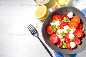 Tomato mozzarella Caprese salad with basil and olive oil. Mediterranean Italian food concept