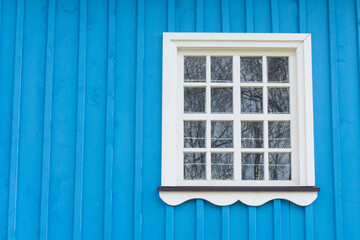 Wooden window background. Rustic cottage house wall. Vintage cabin white paint window frame. Blue paint countryside architecture texture.